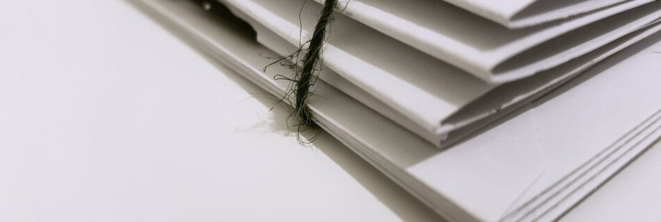 white paper folders with black tie