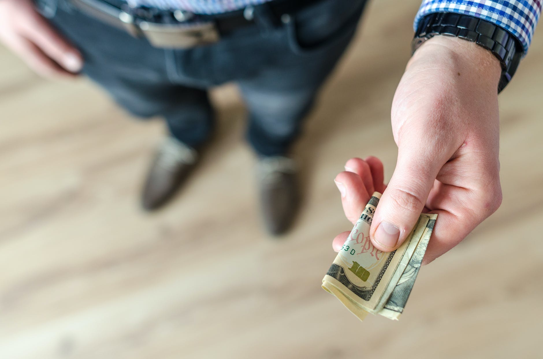 person holding banknote